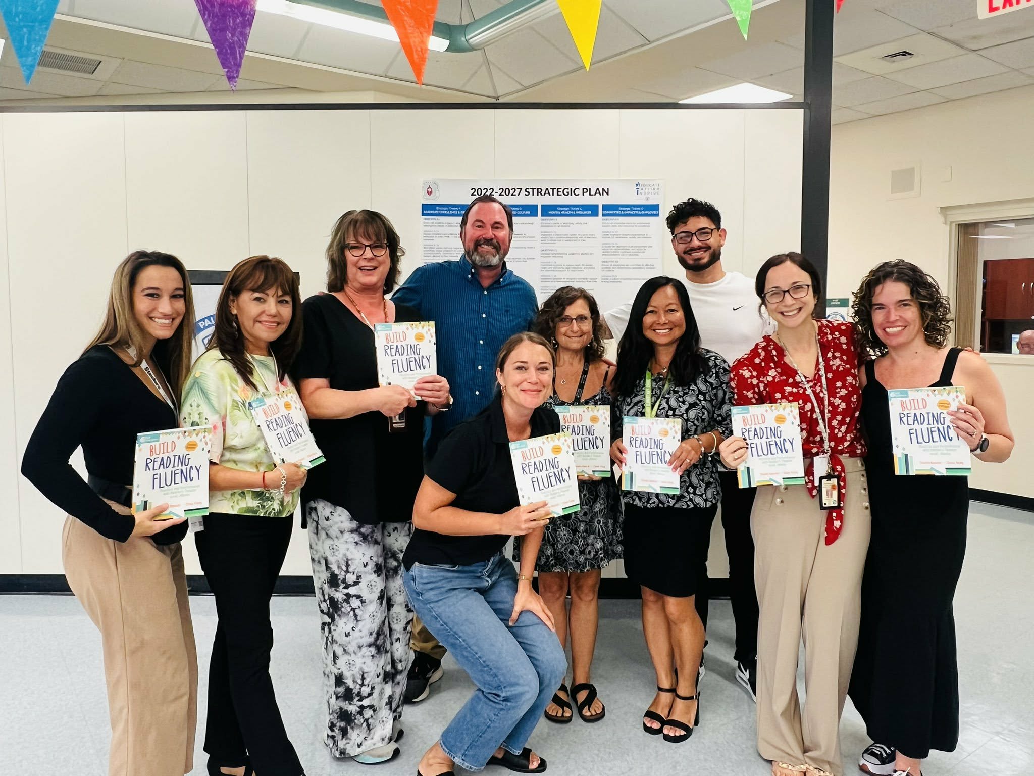Teachers holding reading fluency books